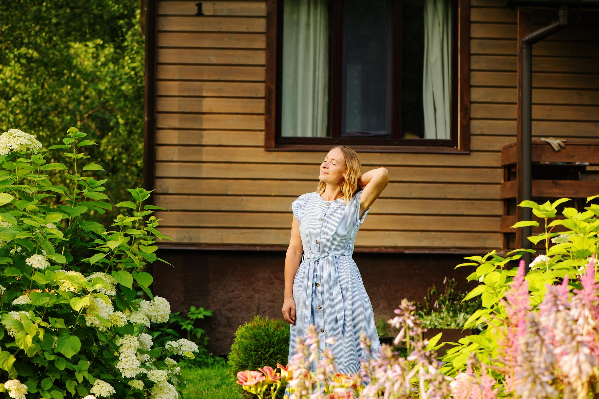 woman-standing-by-potted-plants